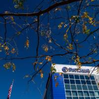 Photo looking up at building with Grand Valley logo on it
